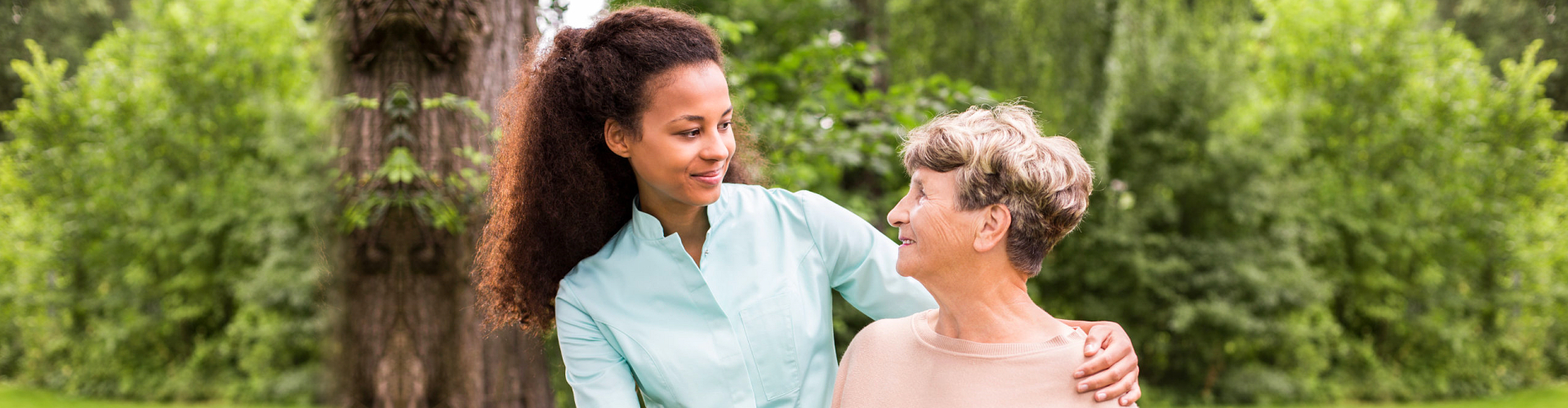 caregiver and senior woman smiling outdoor